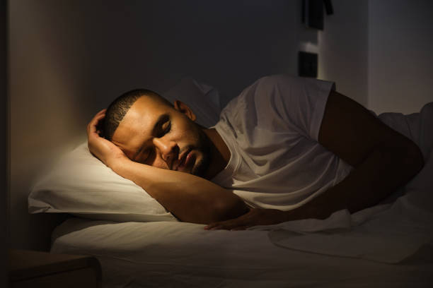 Hero: 3am, dark bedroom, wearable glow on the nightstand