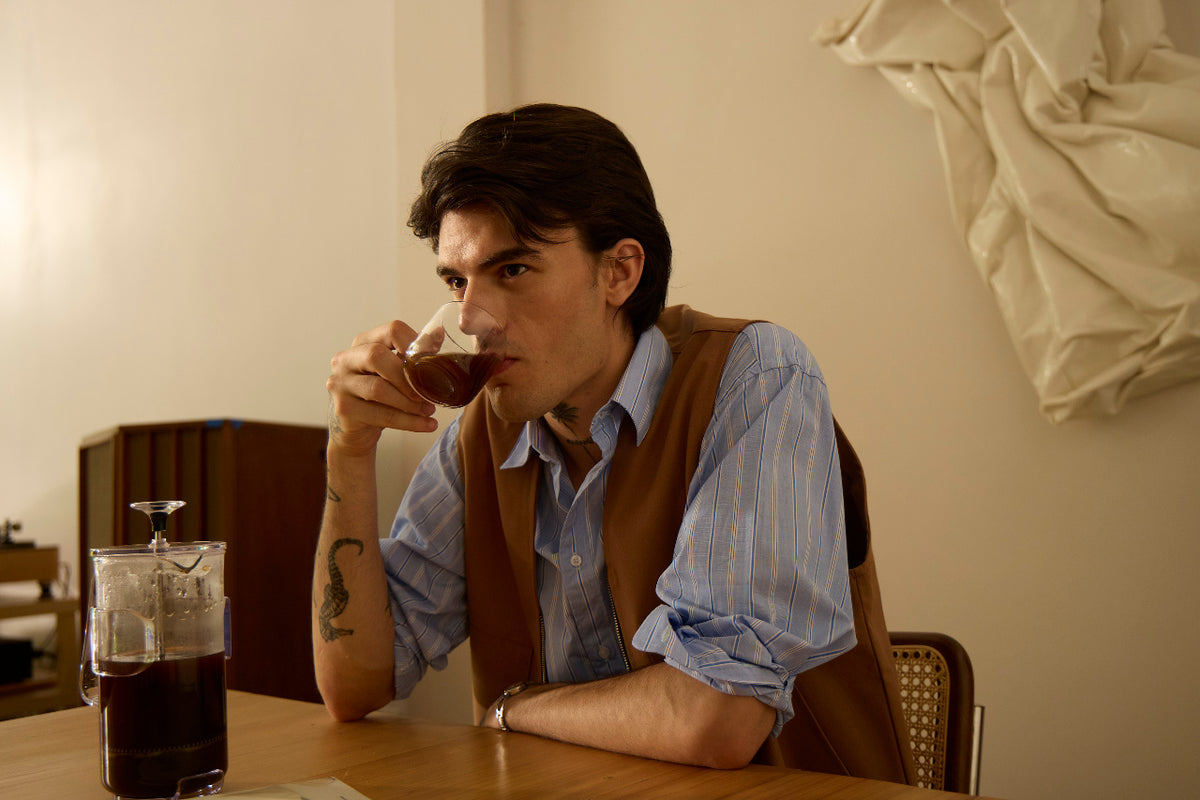 Hero: third coffee of the day on a desk, late afternoon light