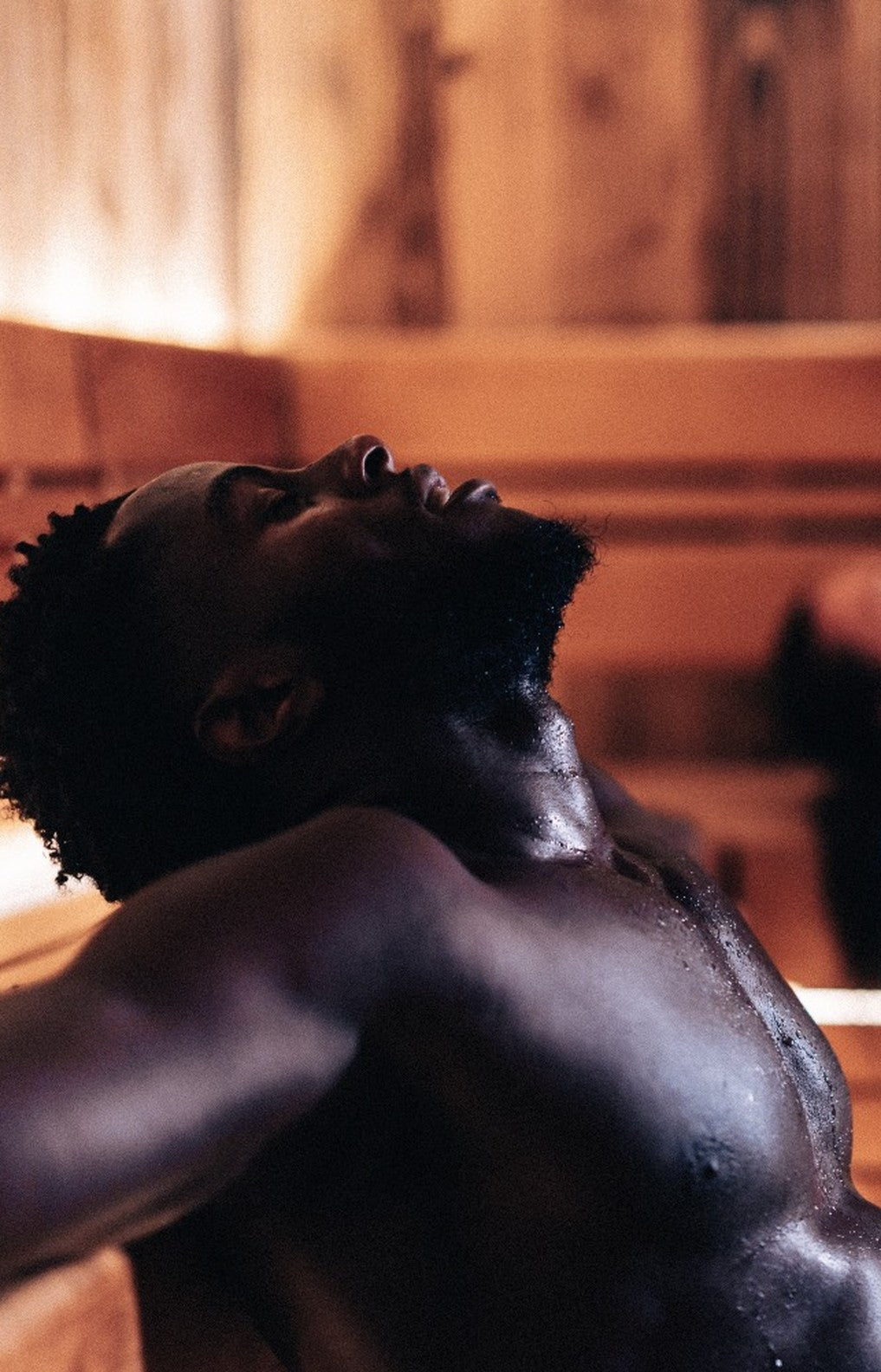 A woman asleep, lit by low warm light
