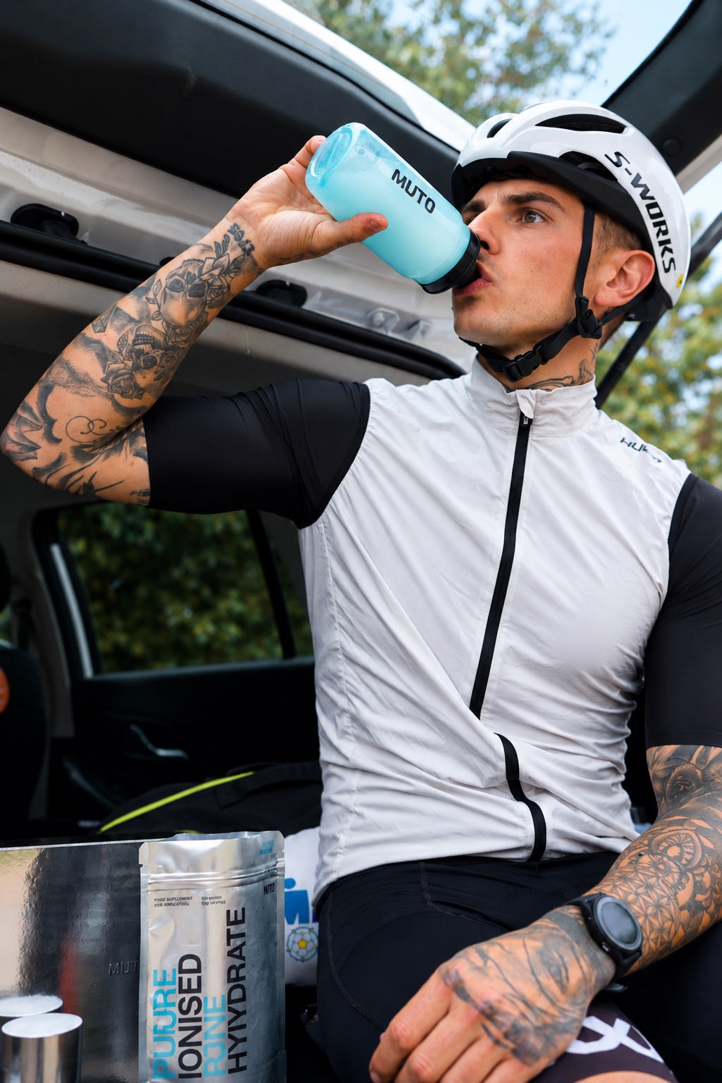 A scoop of creatine being stirred into a glass of water